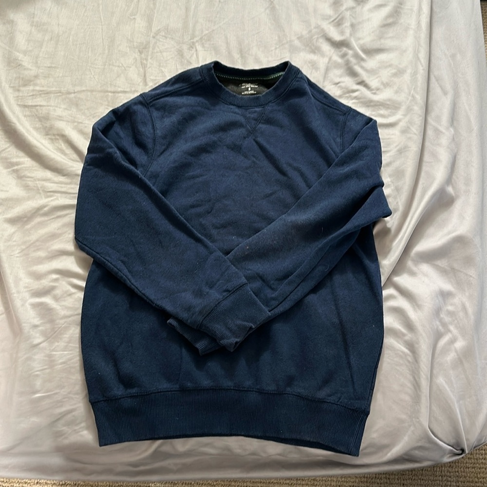 Dark blue crew neck sweater in used condition